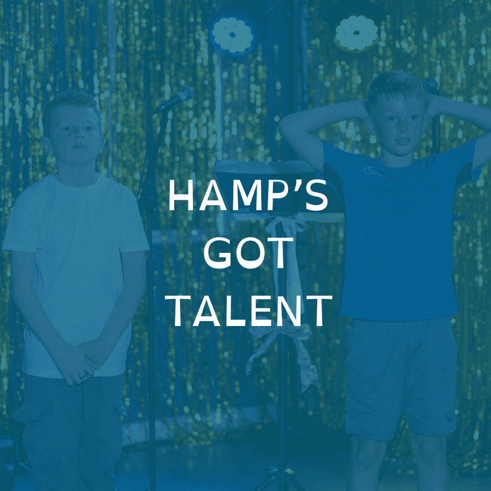 hampsgottalent “Two boys standing on a stage with gold tinsel backdrop and stage lights, with the text ‘Hamp’s Got Talent’ overlaid in the centre.”